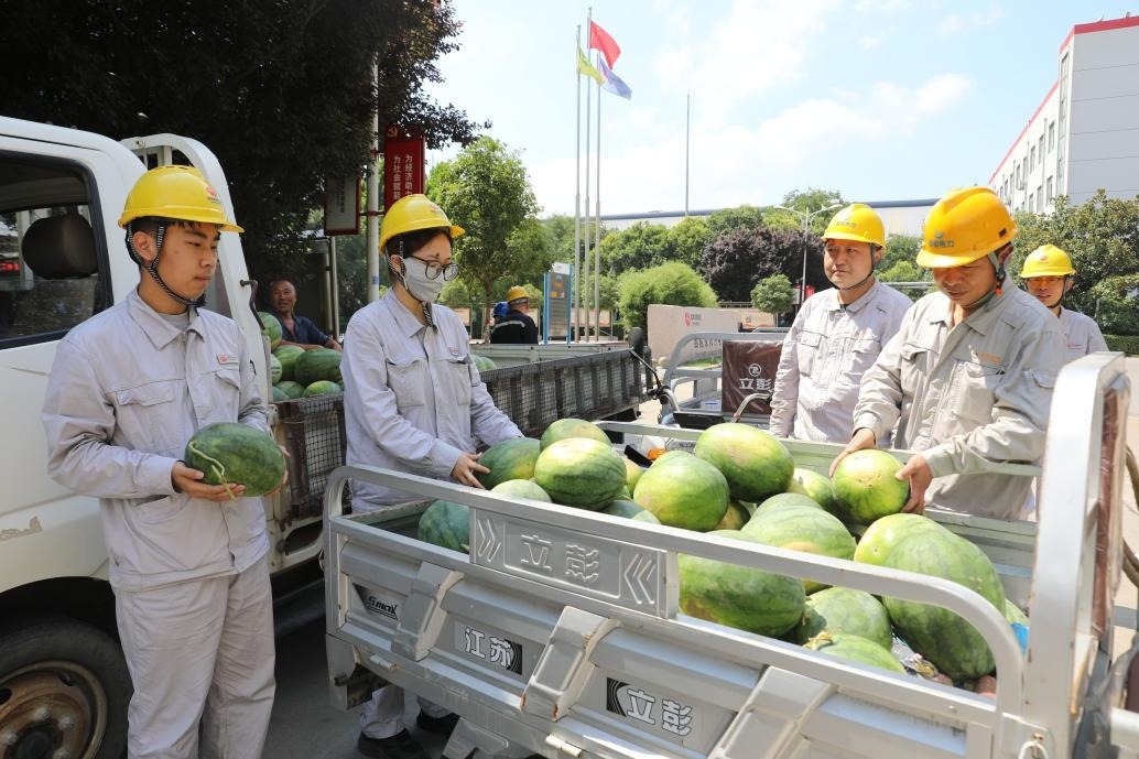 图为该公司员工在领西瓜.jpg